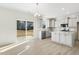 Bright kitchen with island, stainless steel appliances, and granite countertops at 26 Steppe Way, Garner, NC 27529