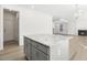 Kitchen island with granite countertop and gray cabinets at 26 Steppe Way, Garner, NC 27529