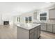 Open concept kitchen with island and living room view at 26 Steppe Way, Garner, NC 27529
