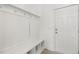 White mudroom with bench and hooks for coats and bags at 26 Steppe Way, Garner, NC 27529