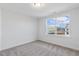 Well-lit bedroom featuring a large window and carpeted floor at 36 Steppe Way, Garner, NC 27529