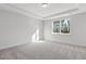 Spacious bedroom with carpeted floors and large window at 36 Steppe Way, Garner, NC 27529