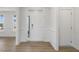 White door entryway with wood-look flooring and wainscoting at 36 Steppe Way, Garner, NC 27529