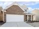 Two-story brick home with a white garage door at 36 Steppe Way, Garner, NC 27529