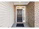 Dark brown front door with sidelights, located on a covered porch at 36 Steppe Way, Garner, NC 27529