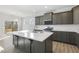Modern kitchen with dark cabinets, island, and stainless steel appliances at 36 Steppe Way, Garner, NC 27529
