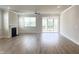 Living room with a fireplace, ceiling fan, and access to a screened porch at 428 Fast Pitch Ln, Four Oaks, NC 27524