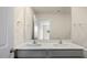 Double vanity bathroom with modern fixtures and large mirror at 160 Perseus St, Angier, NC 27501