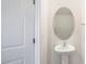 Clean and updated half bathroom with pedestal sink and oval mirror at 160 Perseus St, Angier, NC 27501