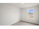 Bright bedroom with carpeted floor and a large window at 160 Perseus St, Angier, NC 27501