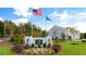 Community entrance sign with landscaping and American and state flags at 160 Perseus St, Angier, NC 27501