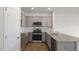 L-shaped kitchen with granite countertops and stainless steel appliances at 160 Perseus St, Angier, NC 27501