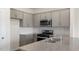 Modern kitchen with gray cabinets and granite countertops at 160 Perseus St, Angier, NC 27501
