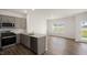 Open concept kitchen and dining area with hardwood floors and backyard view at 160 Perseus St, Angier, NC 27501