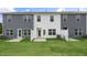 Rear view of two townhouses with patios and fenced yards at 160 Perseus St, Angier, NC 27501