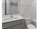 Clean bathroom with gray vanity, white toilet and bathtub at 168 Perseus St, Angier, NC 27501