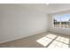 Well-lit bedroom featuring carpeted floors and a window at 168 Perseus St, Angier, NC 27501