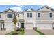 Two-story townhome with gray siding, two-car garage, and landscaping at 168 Perseus St, Angier, NC 27501