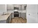 Modern kitchen with gray cabinets, granite countertops, and stainless steel appliances at 168 Perseus St, Angier, NC 27501