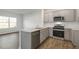 Modern kitchen with gray cabinets, granite countertops, and stainless steel appliances at 168 Perseus St, Angier, NC 27501