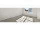 Well-lit bedroom with neutral carpet and large window at 172 Perseus St, Angier, NC 27501