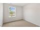 Bright bedroom with large window and neutral carpeting at 172 Perseus St, Angier, NC 27501