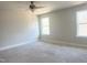 Spacious bedroom with two windows and ceiling fan at 414 Fast Pitch Ln, Four Oaks, NC 27524