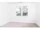 Bedroom featuring carpeted floors, white walls, and a large window with a view of the exterior at 7404 Prato Ct, Wendell, NC 27591