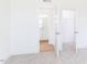 Bedroom featuring carpeted floors, white walls, and open doors to a bathroom and closet at 7404 Prato Ct, Wendell, NC 27591