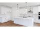 Spacious white kitchen features stainless steel appliances, pendant lighting, and a large island at 7404 Prato Ct, Wendell, NC 27591