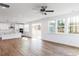 Open living space with hardwood floors, a kitchen featuring a center island, and plenty of natural light at 7404 Prato Ct, Wendell, NC 27591