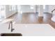 Open concept living room with hardwood floors, large windows, and plenty of natural light at 7404 Prato Ct, Wendell, NC 27591