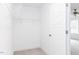 Bright, white walk-in closet with shelving, door to bedroom with carpet at 7404 Prato Ct, Wendell, NC 27591