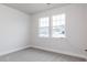 Bedroom with large windows and carpeted floor at 386 Fast Pitch Ln, Four Oaks, NC 27524