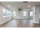 Bright, open living room featuring wood-look floors, recessed lighting, and ample windows at 386 Fast Pitch Ln, Four Oaks, NC 27524