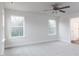 Bedroom with large windows and carpeted floor at 386 Fast Pitch Ln, Four Oaks, NC 27524