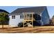 Image of a house's backyard featuring a screened porch, set against a backdrop of a clear sky at 398 Fast Pitch Ln, Four Oaks, NC 27524