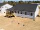 Spacious backyard featuring gray siding, new construction, a porch, and green space at 472 Barbour Farm Ln, Four Oaks, NC 27524