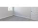 An empty bedroom featuring neutral carpet, a window with natural light, and fresh white trim at 472 Barbour Farm Ln, Four Oaks, NC 27524