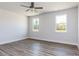 Bright bedroom with luxury vinyl plank flooring and windows providing natural light at 472 Barbour Farm Ln, Four Oaks, NC 27524