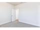 Empty bedroom with neutral carpet, white trim, and an open door to the rest of the house at 472 Barbour Farm Ln, Four Oaks, NC 27524