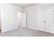 A bedroom with neutral carpet, white trim and doors, and plentiful natural light at 472 Barbour Farm Ln, Four Oaks, NC 27524