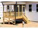Exterior elevation of the screened porch with natural wood, attached to a light gray vinyl home at 472 Barbour Farm Ln, Four Oaks, NC 27524
