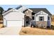 Inviting home showcasing stone accents, white siding, an attached garage, and newly installed landscaping at 472 Barbour Farm Ln, Four Oaks, NC 27524