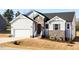 Charming home featuring stone accents, white siding, an attached garage, and fresh landscaping at 472 Barbour Farm Ln, Four Oaks, NC 27524