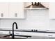 New kitchen features stainless vent hood, subway tile backsplash, and dark granite counters at 472 Barbour Farm Ln, Four Oaks, NC 27524