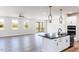 Open concept living space with wood-look floors, white walls, modern fixtures, and sliding glass doors at 472 Barbour Farm Ln, Four Oaks, NC 27524