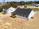 New home featuring a dark roof, screened porch and light siding in a grass backyard at 472 Barbour Farm Ln, Four Oaks, NC 27524