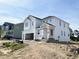 Two-story white home featuring an attached two-car garage and covered porch at 504 Barbour Farm Ln, Four Oaks, NC 27524