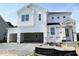 Two-story white home with an open two-car garage and covered entryway at 504 Barbour Farm Ln, Four Oaks, NC 27524